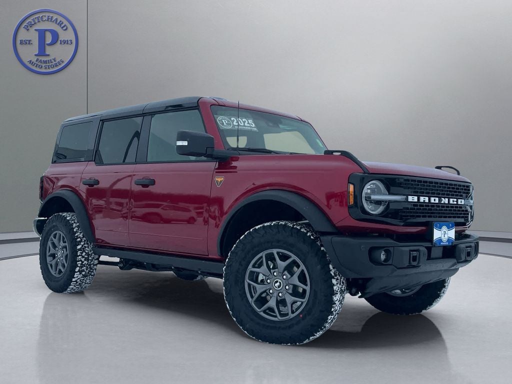 2025 Ford Bronco Badlands in Ruby Red Metallic Tinted Clearcoat — front three-quarter view